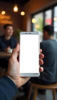 A person holding up a white phone with a blank screen photo