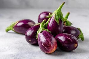 tempting eggplant in the rustic corner on a light gray background photo