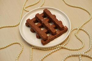 a neatly arranged stack of chocolate covered snack bars photo