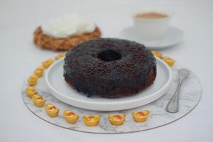 round chocolate donut covered in rich chocolate glaze and topped with chocolate sprinkles photo