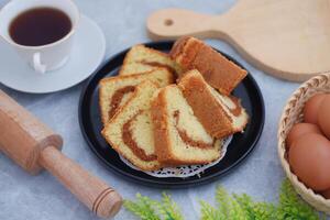Delicious cake slices with a cup of tea on a table photo