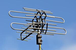 Analog TV antenna blue sky background photo