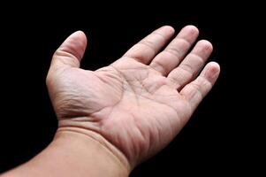 Asian man palms wide open fingers black background photo
