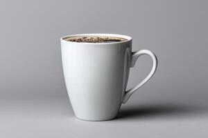Warm cup of coffee on a gray background with rich black brew inside photo
