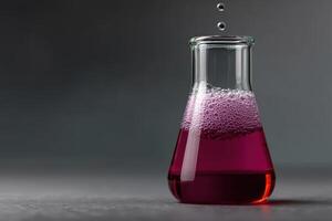 Colorful liquid bubbling in a glass flask during a chemistry experiment in a lab photo