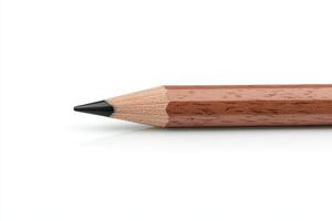 Close up of a sharpened pencil resting on a white surface for creative writing or drawing tasks photo