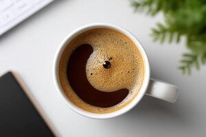 Coffee cup with smiley face foam art in a cozy workspace at morning photo