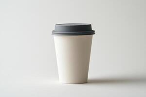 White paper coffee cup with gray lid isolated on white background with sharp detail and minimalistic aesthetic photo