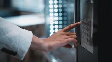 A person is touching a button on a vending machine photo