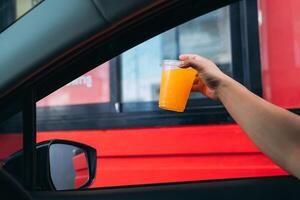 A person holding a drink in their hand photo