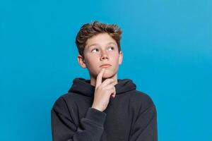 A young boy is looking up at something photo