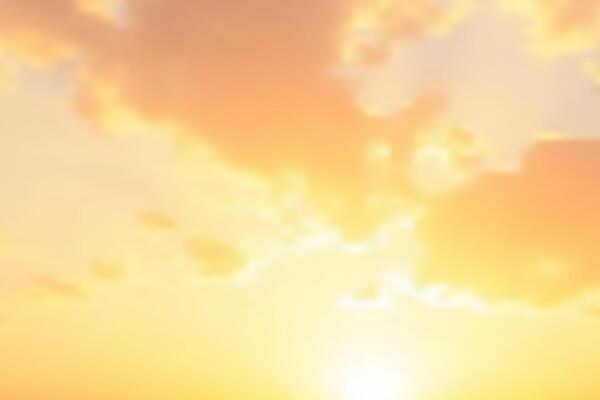 Orange Golden Sky Background. The sky ablaze with a symphony of warm hues and soft textures as the sun descends, casting a breathtaking display of natural artistry.