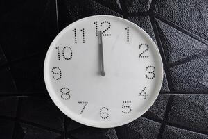 Focus time in clock of twelve o'clock for design in your business concept isolated on black background photo