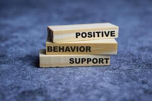 Concept of Positive behavior support Symbol. Wooden block with words Positive behavior support photo