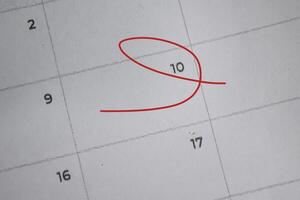 Focus on number 10 in calendar and emptyred ellipse. Save the date. Day of the year concept. photo