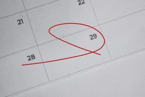 Focus on number 29 in calendar and emptyred ellipse. Save the date. Day of the year concept. photo
