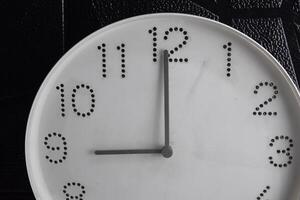 Focus time in clock of nine o'clock for design in your business concept isolated on black background photo