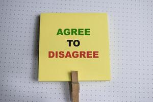 Concept of Agree to Disagree write on sticky notes isolated on Wooden Table. photo