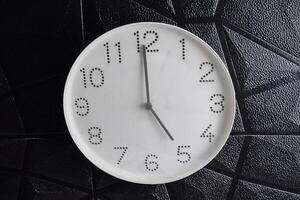 Focus time in clock of five o'clock for design in your business concept isolated on black photo