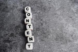 The word content on stacked wooden cubes on the table. content creation or management business information photo