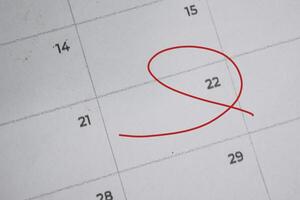 Focus on number 22 in calendar and emptyred ellipse. Save the date. Day of the year concept. photo