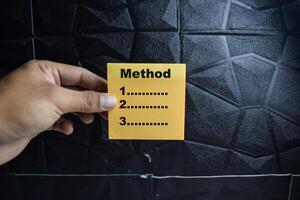 Concept of Method write on sticky notes isolated on Wooden Table. photo