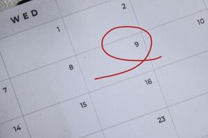 Focus on number 9 in calendar and emptyred ellipse. Save the date. Day of the year concept. photo
