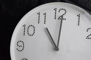 Focus time in clock of eleven o'clock for design in your business concept isolated on black background photo