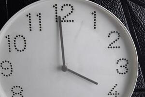time in clock of four o'clock for design in your business concept isolated on black background photo