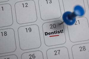 20th day of the month. writing text Dentist on calendar date. Save the date. Day of the year concept. photo