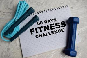 Concept of 60 Days Fitness Challenge write on book isolated on Wooden Table. photo