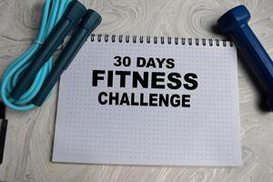 Concept of 30 Days Fitness challenge write on book isolated on Wooden Table. photo