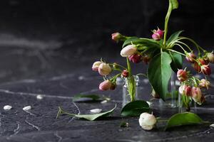 Loose flower petals and stems are scattered around the various elements. photo