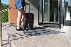 A woman with a suitcase on vacation or traveling. photo