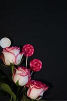 A bouquet of purple and white flowers is wrapped in brown kraft paper and tied with twine photo