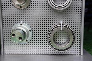 different bearings on a metal background. Part of mechanism micrometer. photo