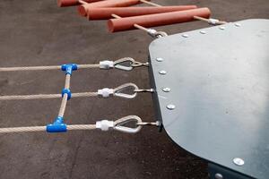 Steel turnbuckle and sling steel or Steel Wire Rope Sling and metal cable clamp connected with screw bolt. Device for adjusting the tension or length of cable on a blue sky background. Copy space. photo