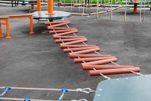 Children Playground with Modern Slide, Climbing Swings, Climbers. Empty Wooden Playground made of Eco Materials photo