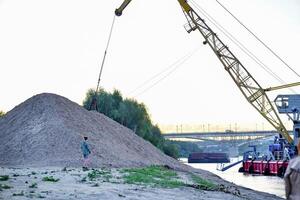 River in mountain region in Vietnam. Excavator tnker. photo