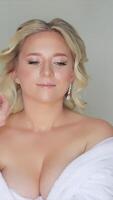 Bride Final Touches Captured on Camera. A behind-the-scenes moment capturing a bride getting the final touches on her earrings while a photographer documents video