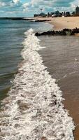Aerial view of shoreline with crashing waves, sandy coast at Coney Island Beach in Brooklyn video
