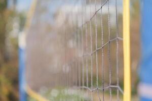 Beach volleyball net on a sunny day, shallow depth of field photo