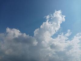 Fluffy white clouds against a vibrant blue sky photo