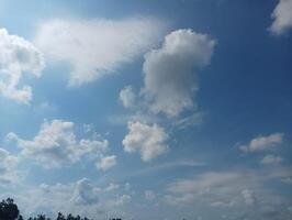 Bright Sky with Fluffy Clouds on a Sunny Day photo