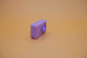 Toy Digital Camera in Purple with LED Light Turned On photo