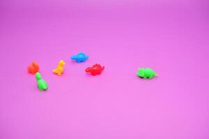 Vibrant Dinosaur Toys Lined Up on a Colorful Surface photo