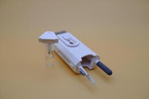 Compact Cleaning Device with Fine-Tip Brush and Liquid Spray Bottle photo