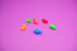Group of Tiny Dinosaur Toys in a Circle on Bright Surface photo