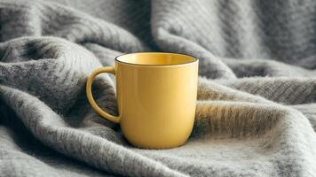 Yellow Mug on Grey Blanket photo