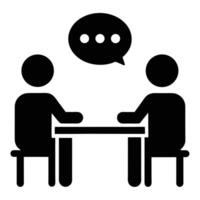 Two people sitting at a table with a speech bubble symbolizing communication vector